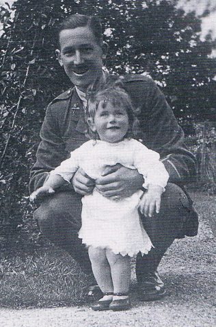 Wilfrid in uniform squats to hold his small daughter standing in front of him | With permission from James Waite, Margaret's son